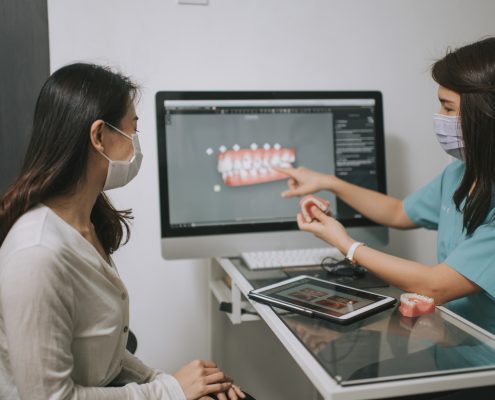 asian chinese female dentist explaining Tooth3D To A Patient